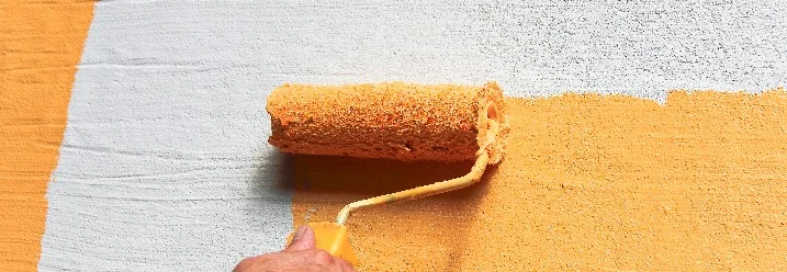 Person streicht Wand orange